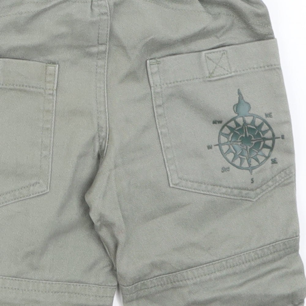 Brand and care label for Adams boys’ green cargo jeans, size 3-6, months