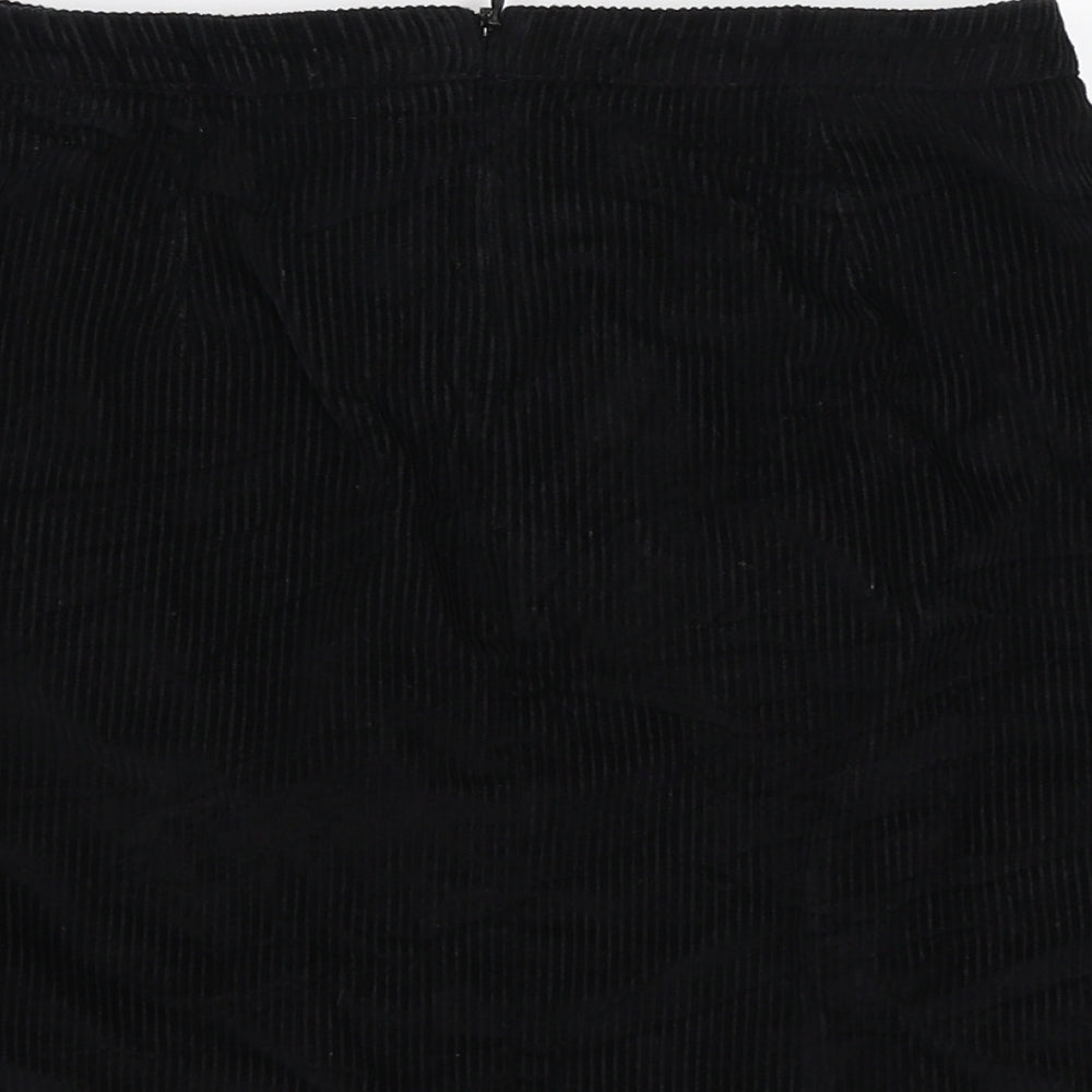 Brand and care label for New Look girls’ black corduroy a-line skirt, size 13, years
