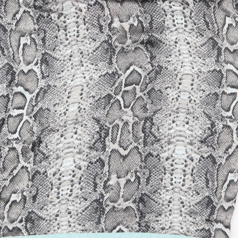 Brand and care label for Dunnes women’s green animal print basic blouse, size M