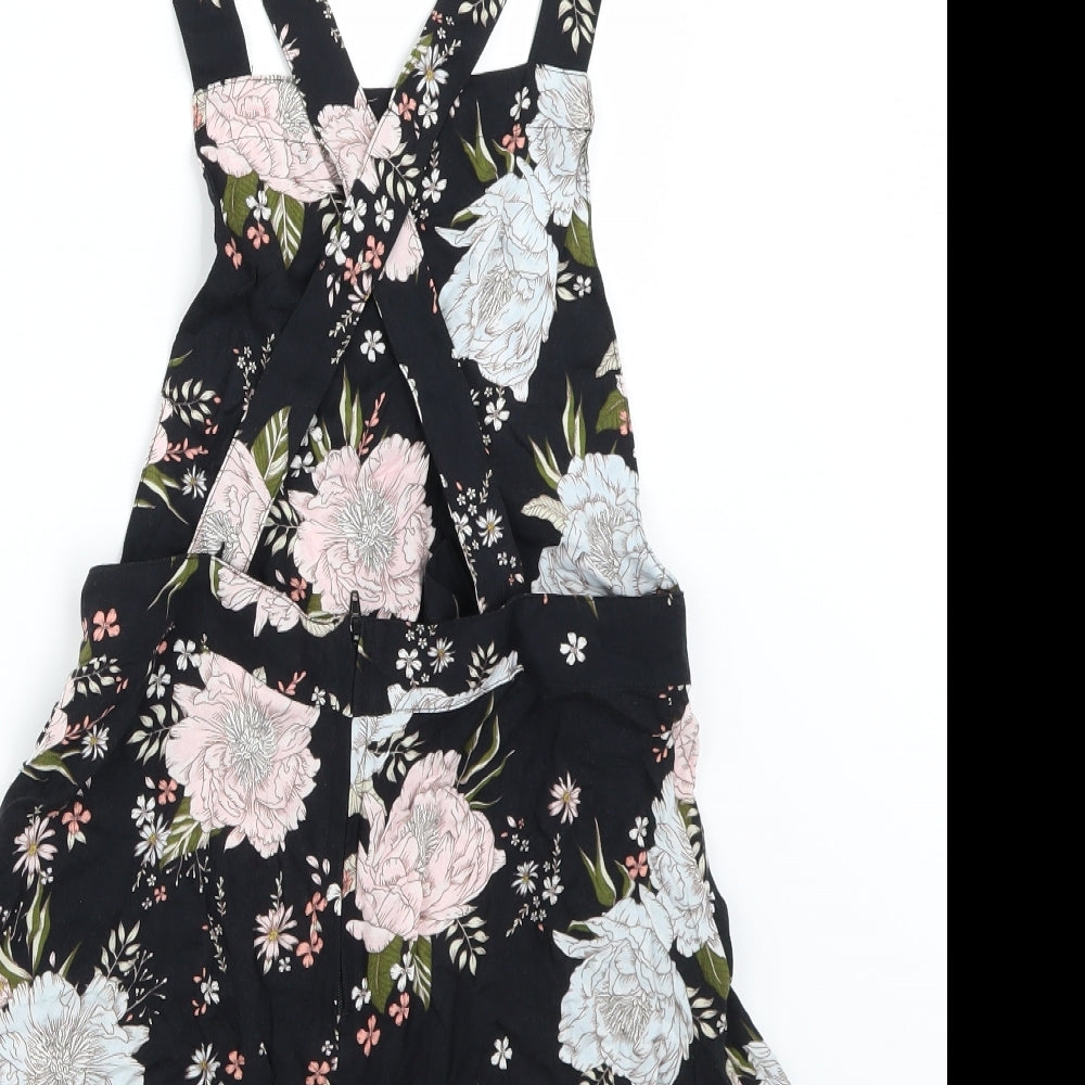 Brand and care label for H&M women’s black floral romper one-piece, size UK 10