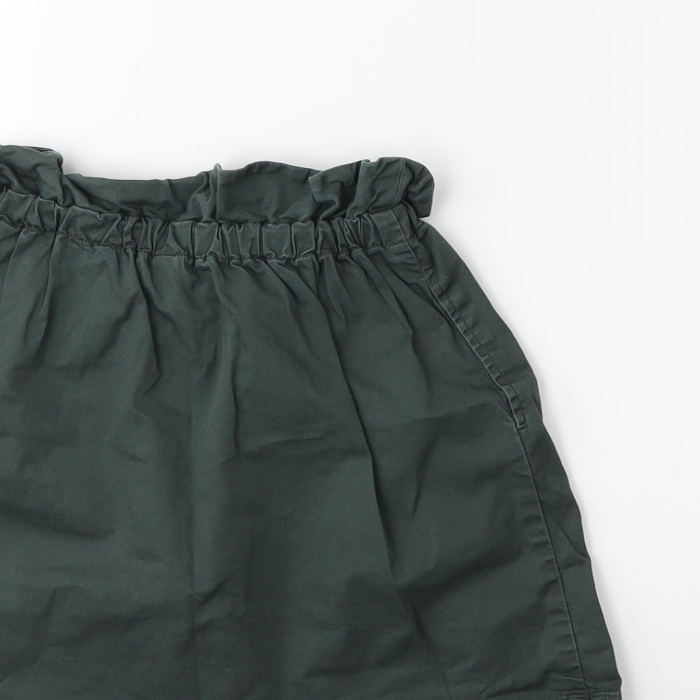 Brand and care label for Uniqlo girls’ grey mini skirt, size 7, years