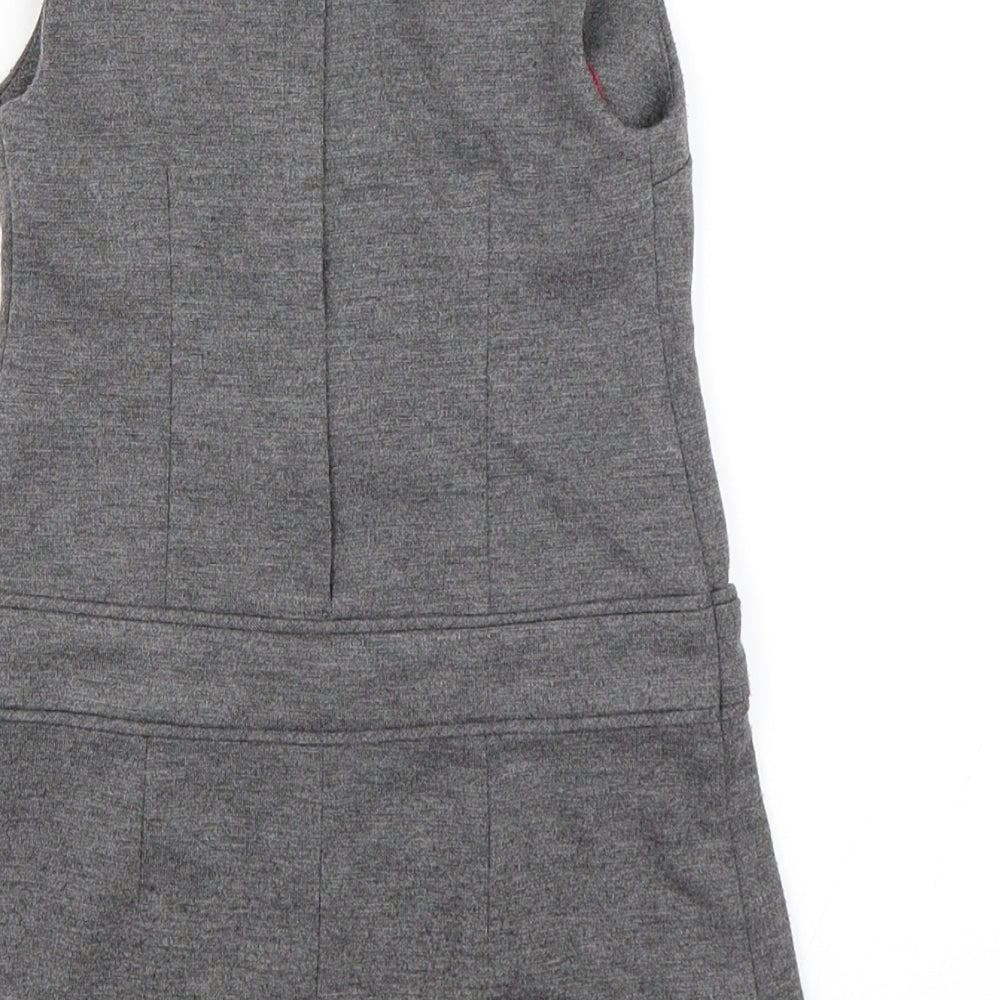 Brand and care label for Miss E-vie girls’ grey pinafore/dungaree dress, size 3, years