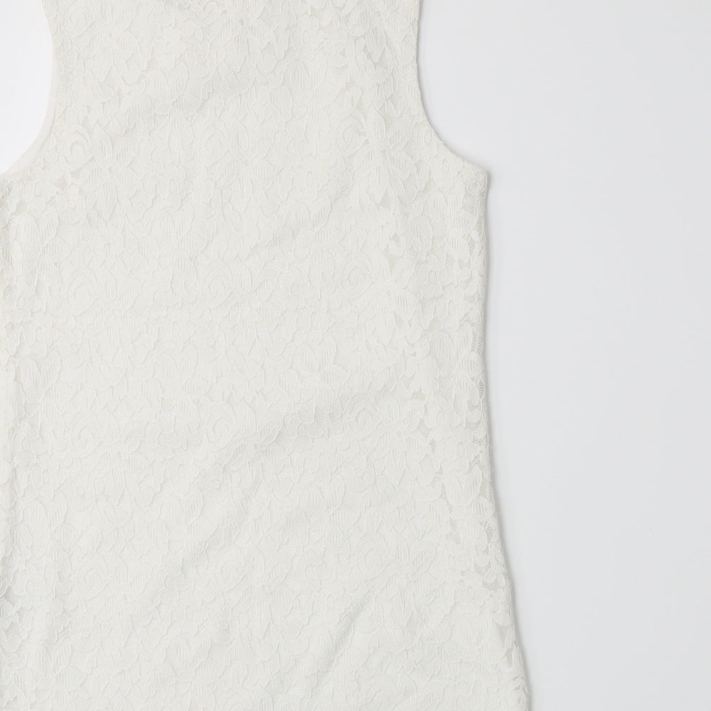 Brand and care label for Lindex girls’ white basic tank, size 10-11, years