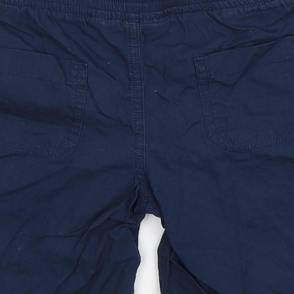 Brand and care label for Urban Rascals boys’ blue bermuda shorts, size 5-6, years