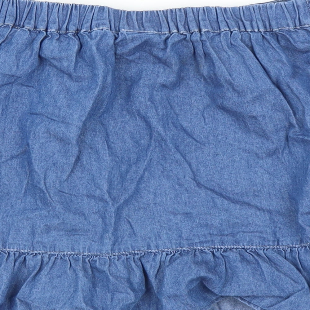 Brand and care label for TU girls’ blue mini skirt, size 9, years