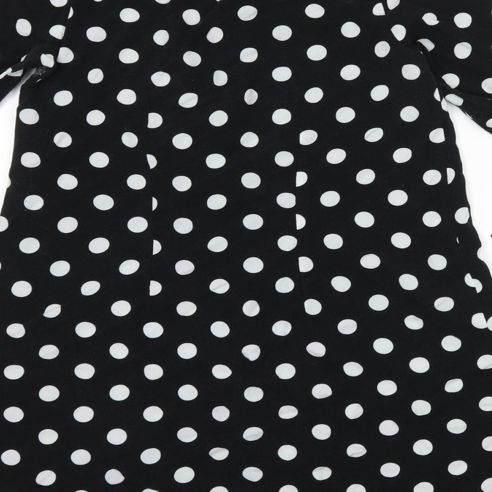 Brand and care label for Primark women’s black polka dot shirt dress, size UK 4