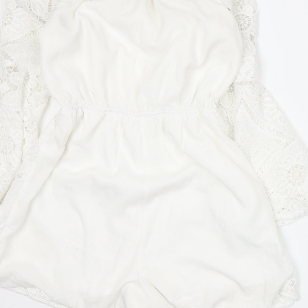 Brand and care label for Parisian women’s white romper one-piece, size UK 8