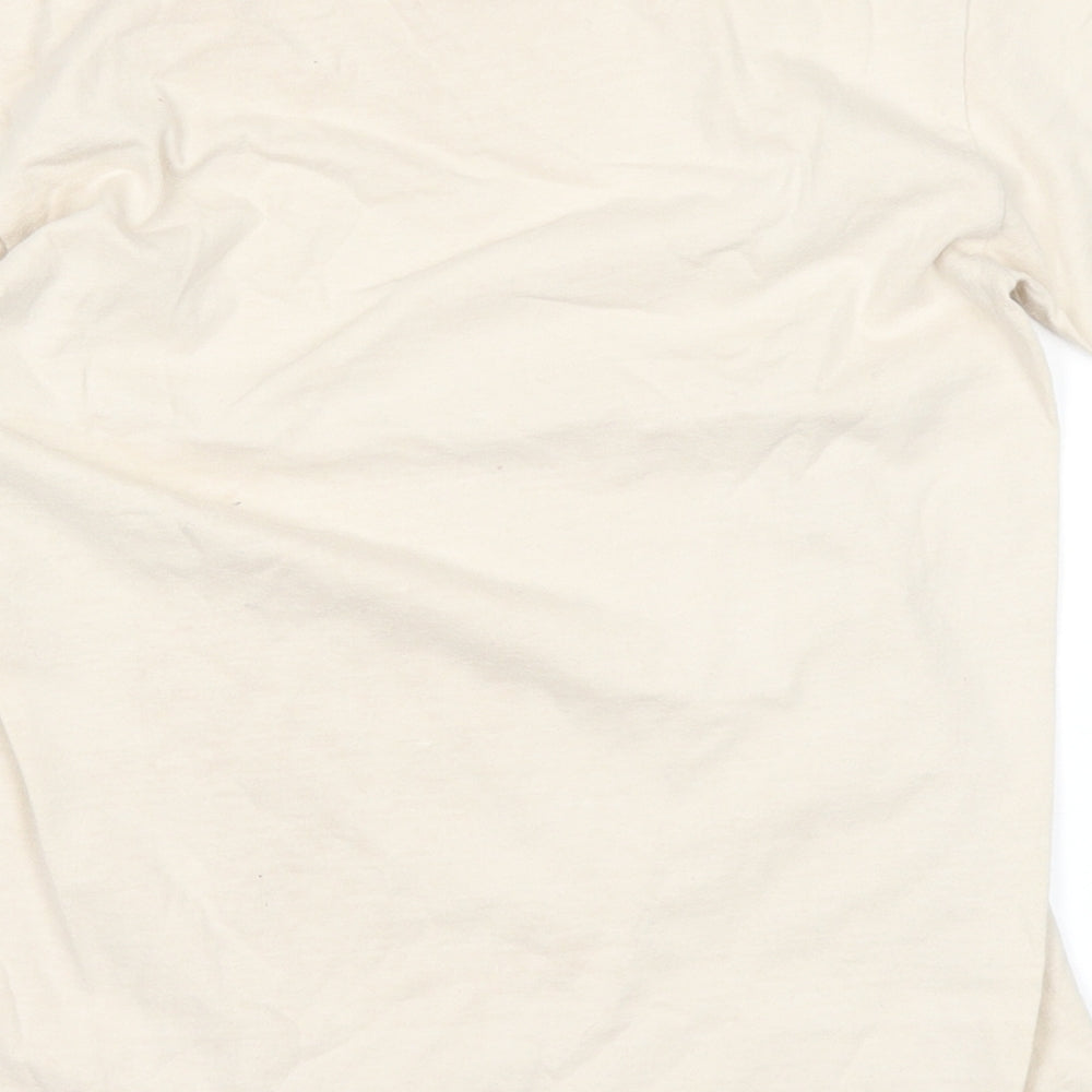 Brand and care label for Crazy Shirts girls’ beige basic t-shirt, size M