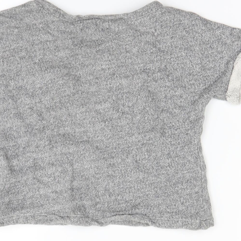 Brand and care label for Gap girls’ grey jumper, size 3-4, years