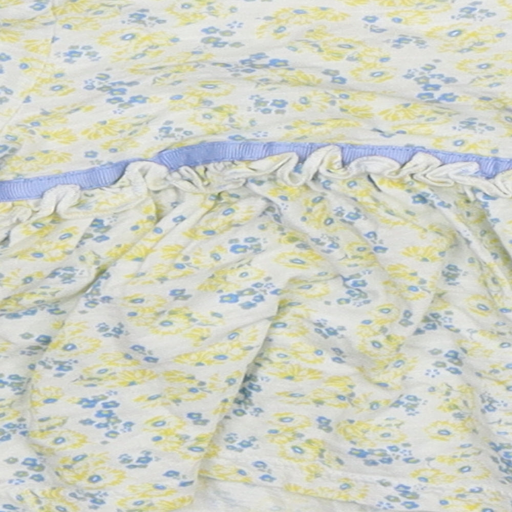 Brand and care label for St Bernard girls’ white floral fit & flare, size 6-9, months