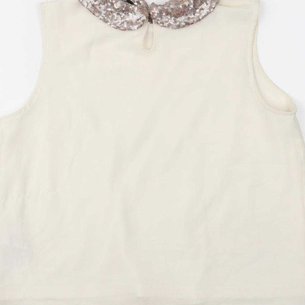 Brand and care label for New Look girls’ white camisole blouse, size 14, years