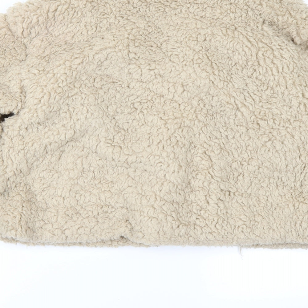 Brand and care label for Rising women’s beige fleece jacket, size M