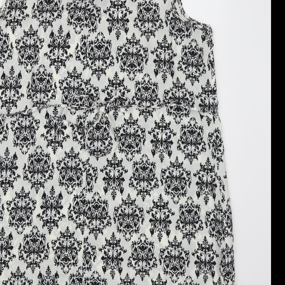 Brand and care label for Peacocks women’s white batik sheath, size M