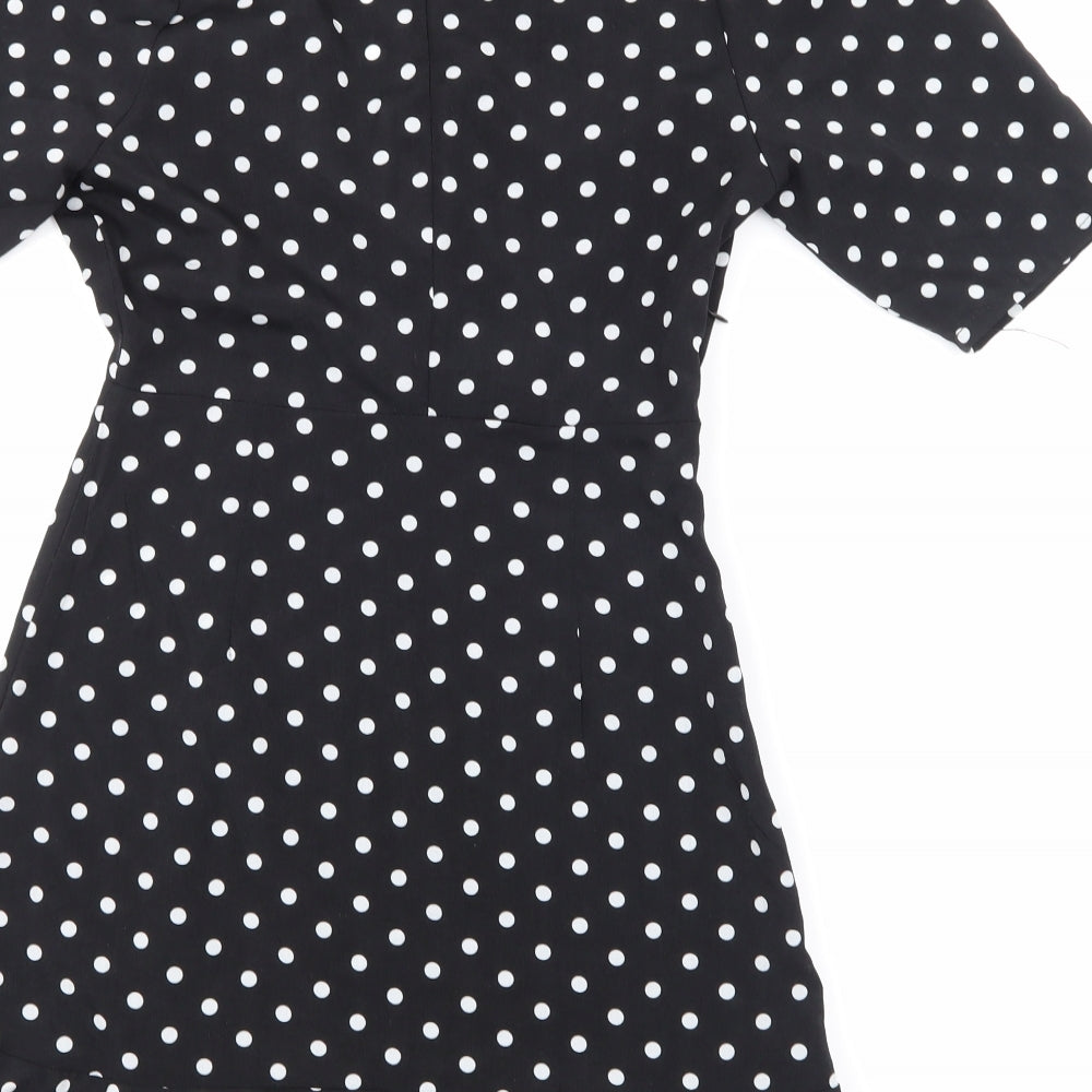 Brand and care label for PRETTYLITTLETHING women’s black polka dot a-line, size UK 2