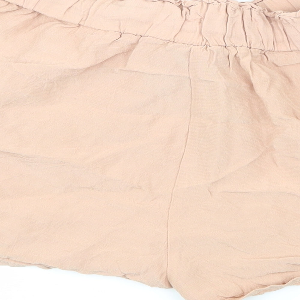 Brand and care label for H&M women’s pink hot pants shorts, size UK 6