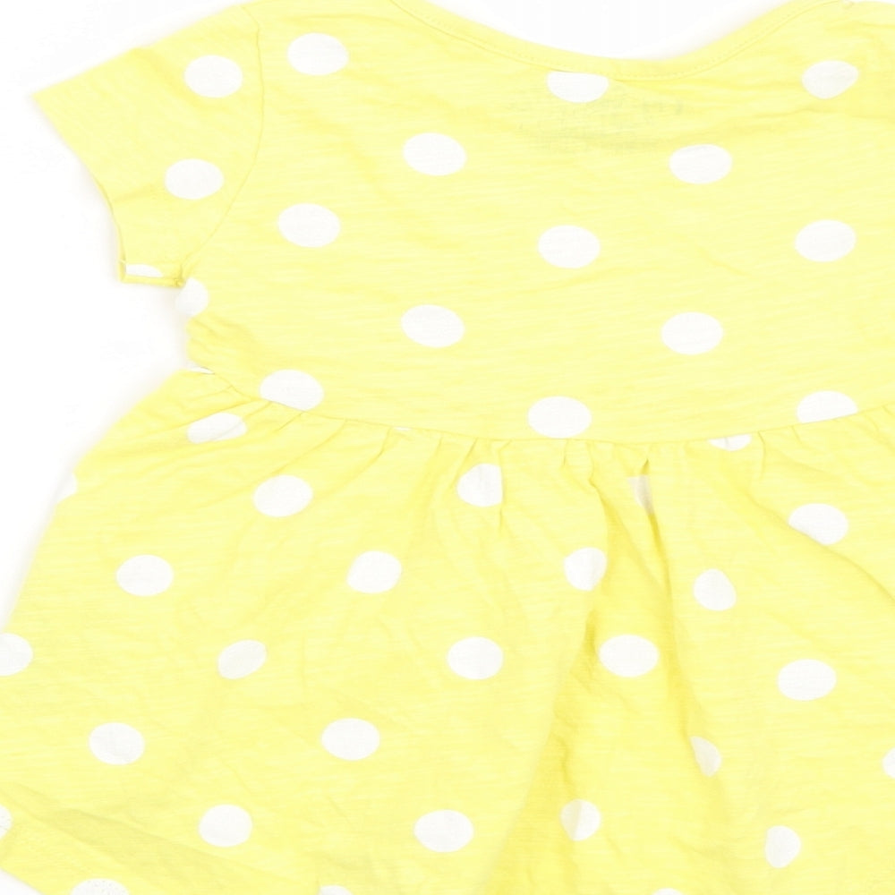 Brand and care label for Next girls’ yellow polka dot t-shirt dress, size 6-9, months
