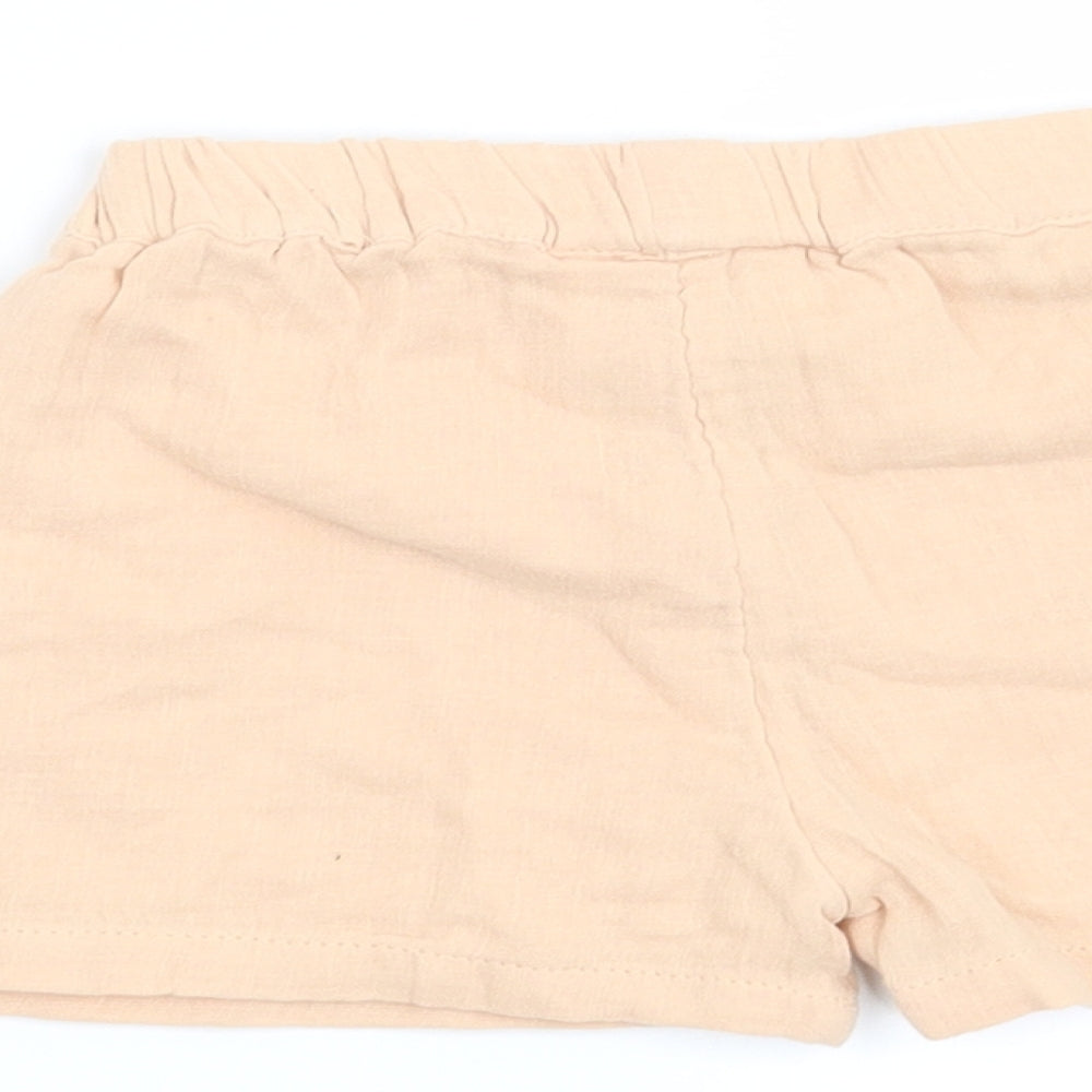 Brand and care label for Marks & Spencer girls’ orange cropped trousers, size 6-9, months