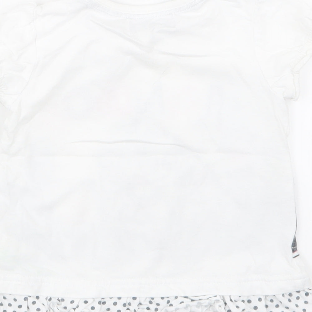 Brand and care label for Disney girls’ white basic t-shirt, size 12-18, months