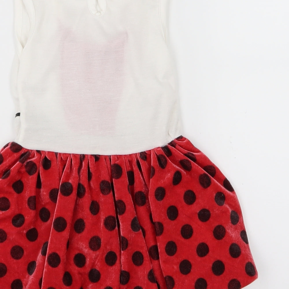 Brand and care label for Seram girls’ red polka dot velour skater dress, size 18-24, months