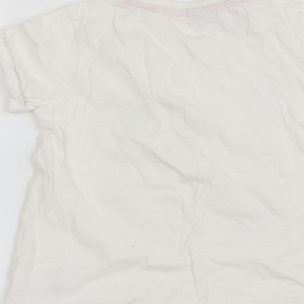 Brand and care label for Tu girls’ white basic t-shirt, size 7, years