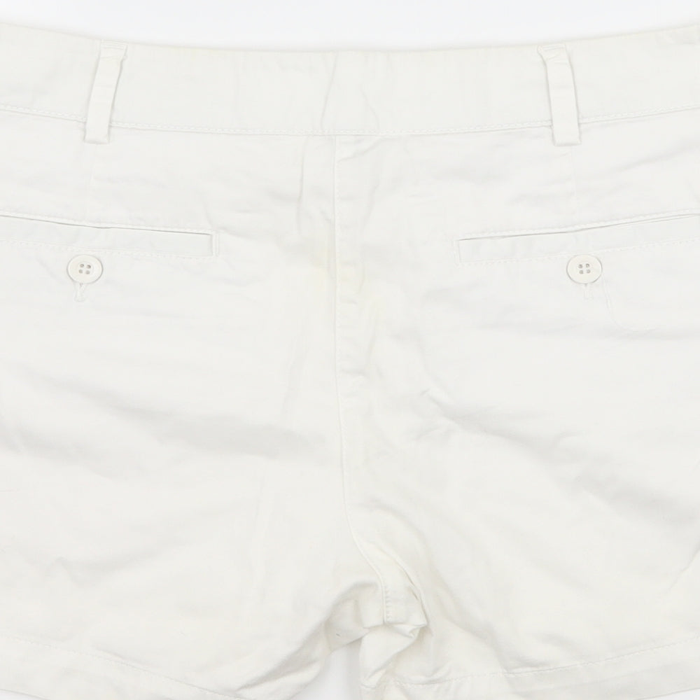Brand and care label for United Colors of Benetton women’s white hot pants shorts, size UK 32, in