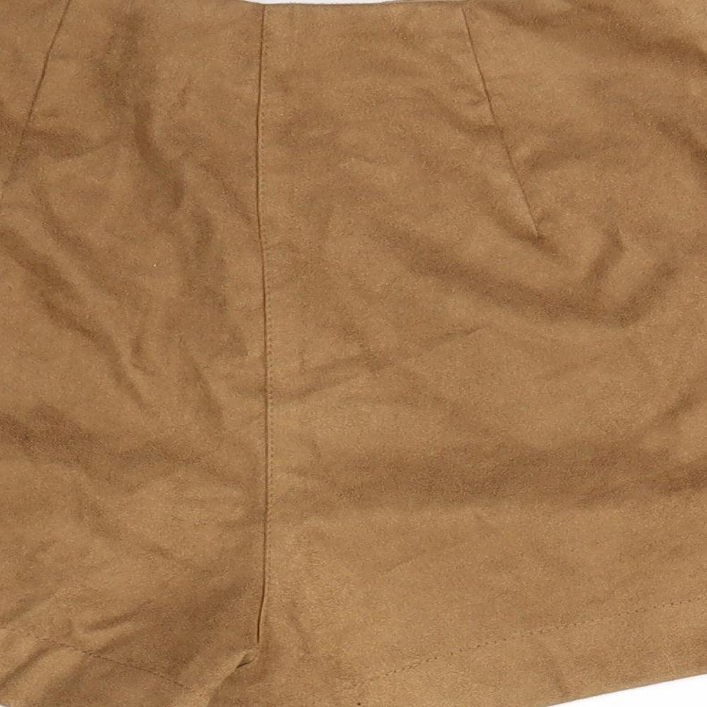 Brand and care label for H&M women’s beige cut-off shorts, size UK 6