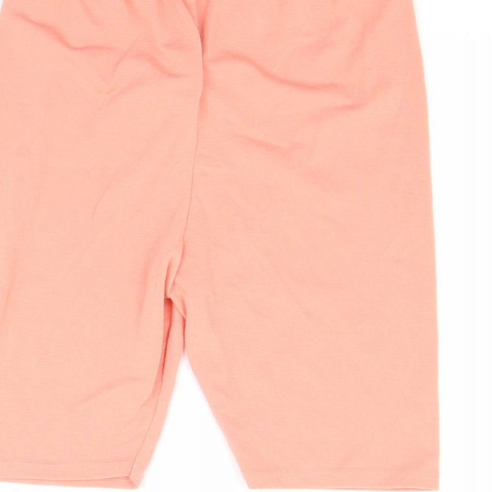 Brand and care label for Missguided women’s orange sweat shorts, size UK 4