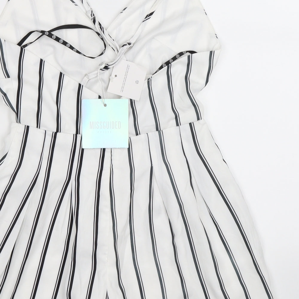 Brand and care label for Missguided women’s white striped playsuit one-piece, size UK 4, 3-inch leg