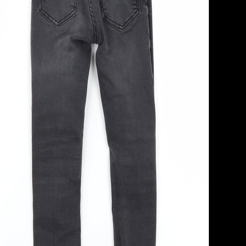 Brand and care label for Tu girls’ black skinny jeans, size 8, years