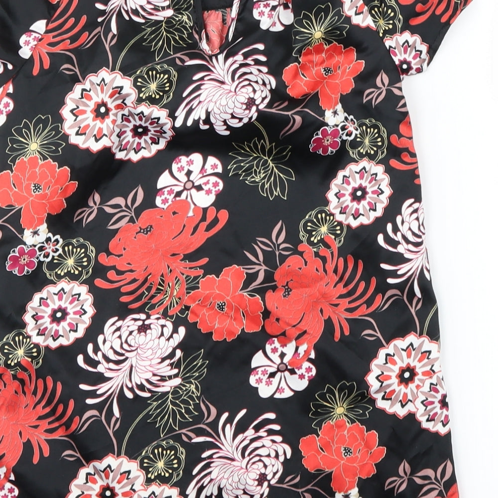 Brand and care label for Debenhams girls’ black floral basic blouse, size 7, years