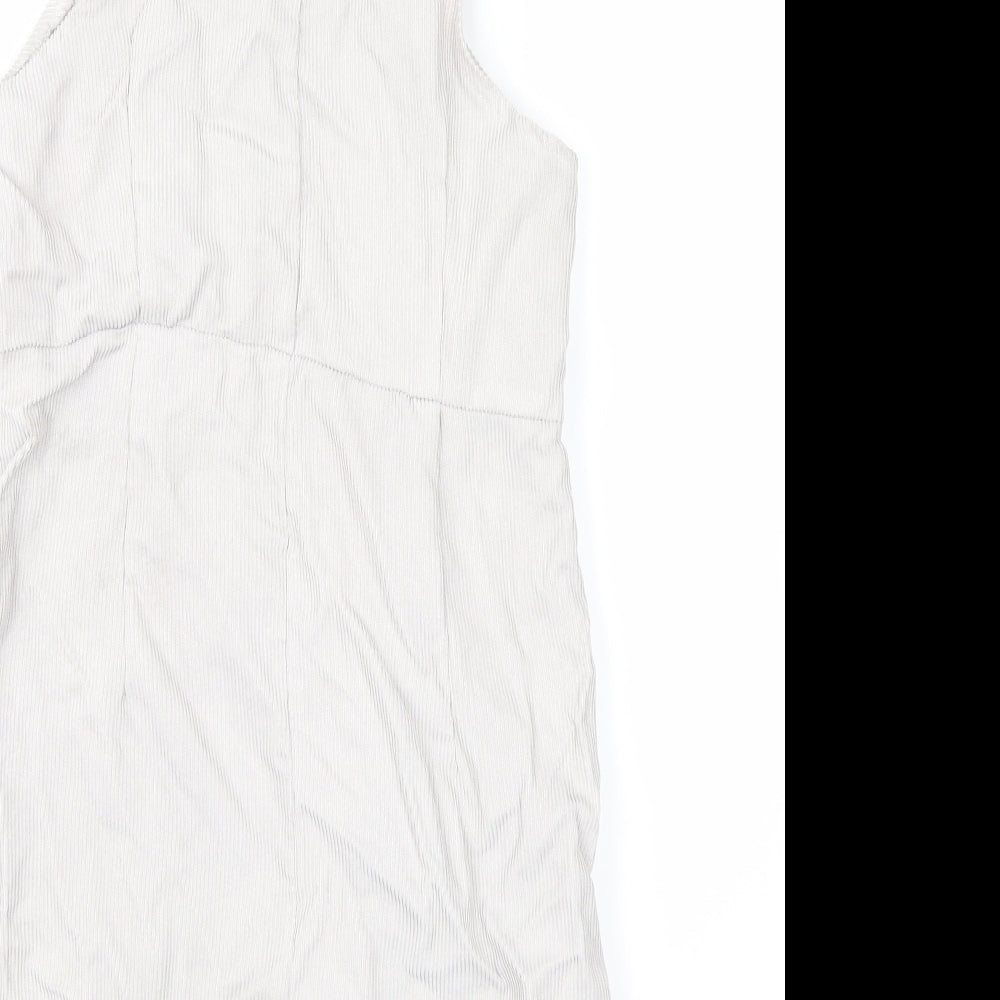 Brand and care label for Boohoo women’s white dungaree one-piece, size UK 10
