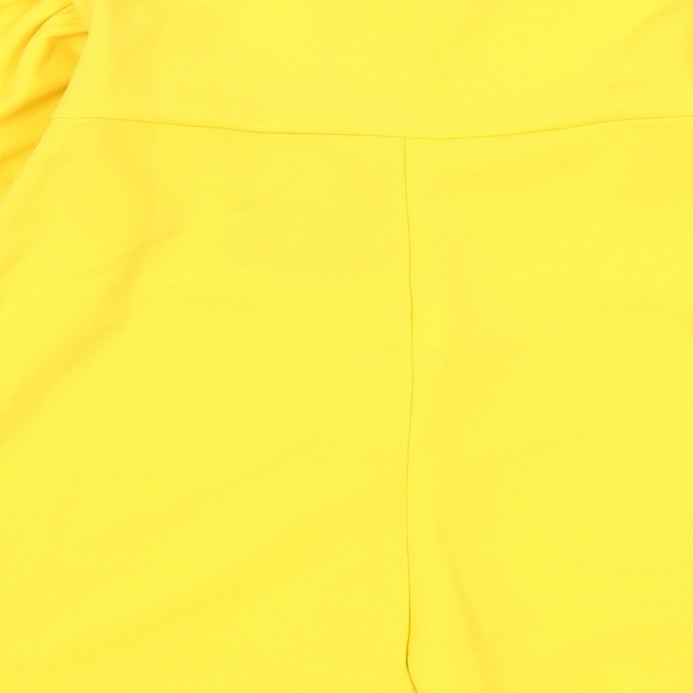 Brand and care label for PRETTYLITTLETHING women’s yellow playsuit one-piece, size UK 6