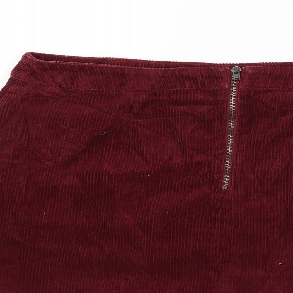 Brand and care label for BDG women’s red corduroy mini skirt, size M
