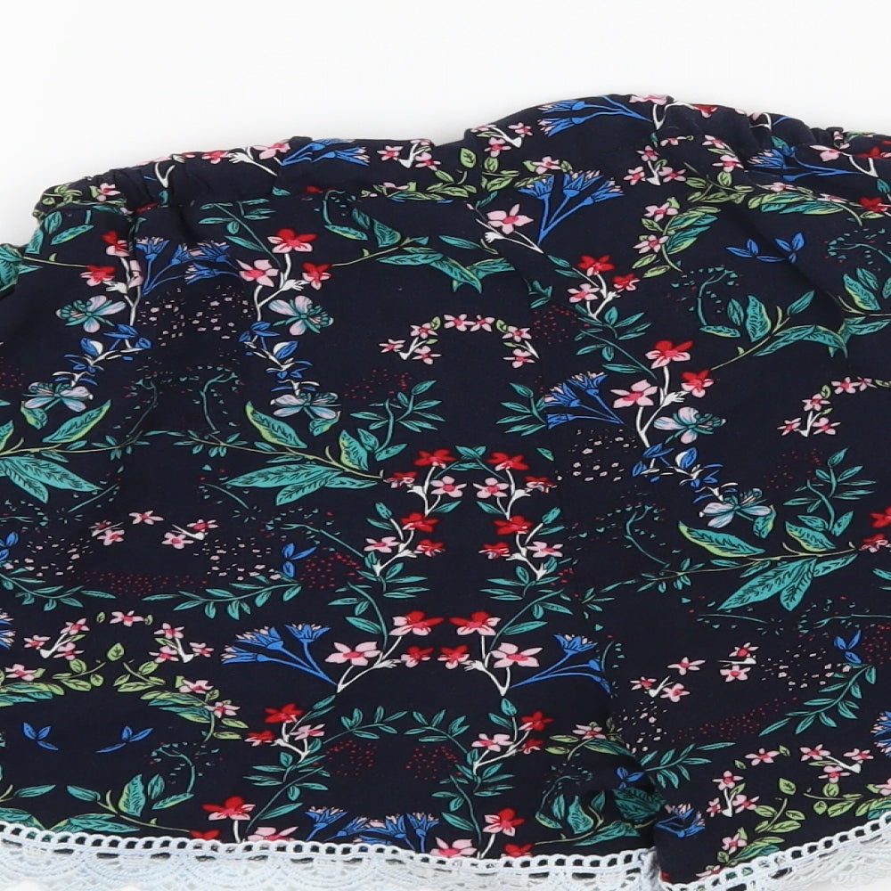 Brand and care label for Preworn women’s black floral paperbag shorts, size M