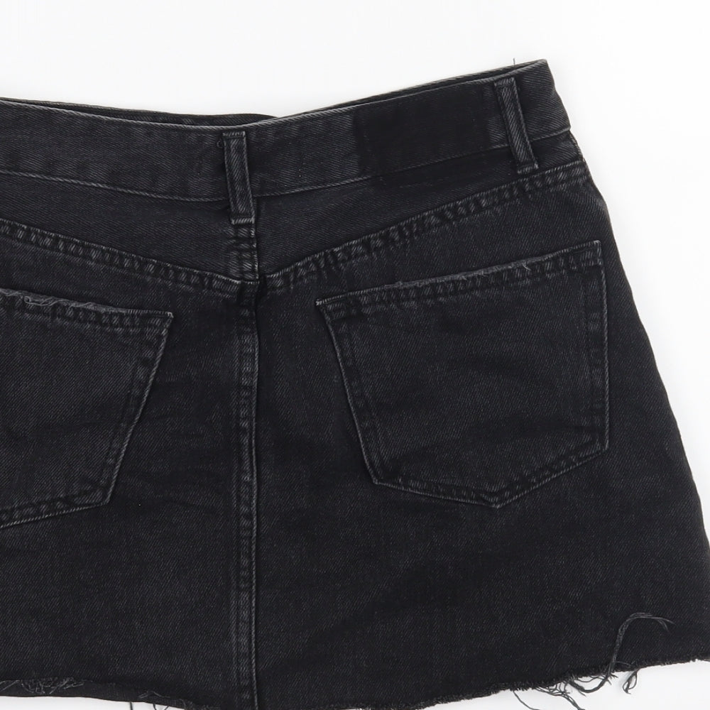 Brand and care label for Bershka women’s black mini skirt, size UK 8