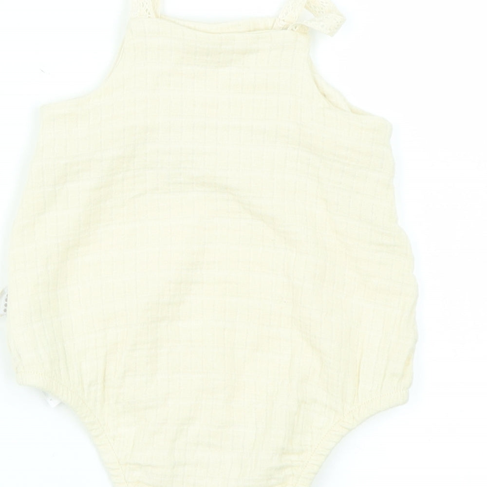 Brand and care label for Preworn girls’ beige babygrow one-piece, size 6-9, months
