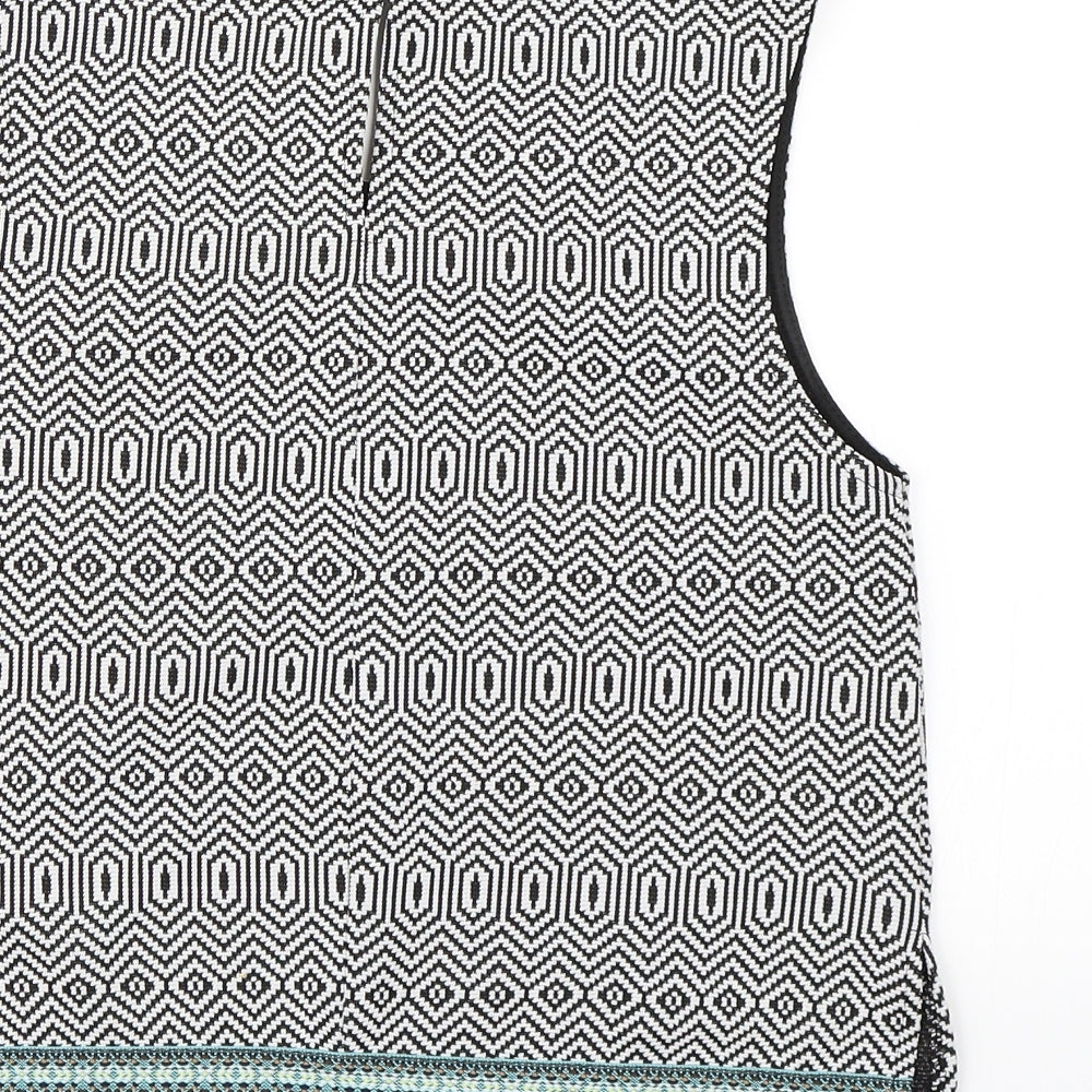 Brand and care label for Candy Couture girls’ black geometric cropped tank, size 14, years