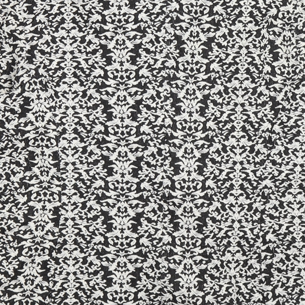 Brand and care label for Next women’s black floral jacket, size UK 16