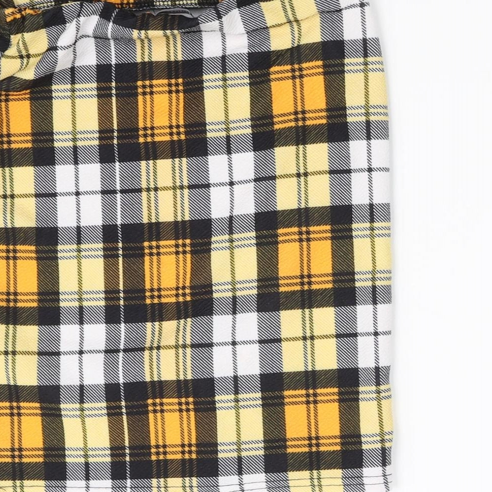 Brand and care label for PRETTYLITTLETHING pretty little thiung women’s yellow mini skirt, size UK 6