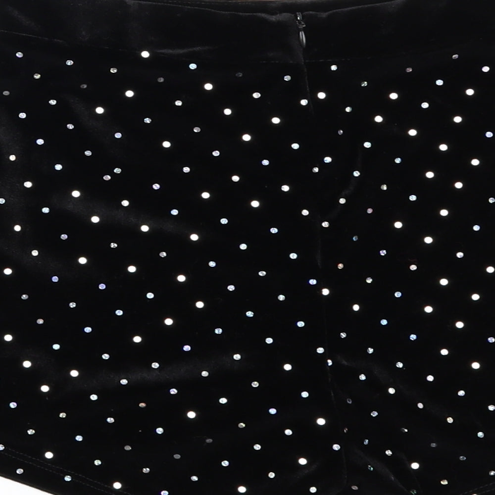 Brand and care label for Bershka women’s black polka dot velour hot pants shorts, size UK 10