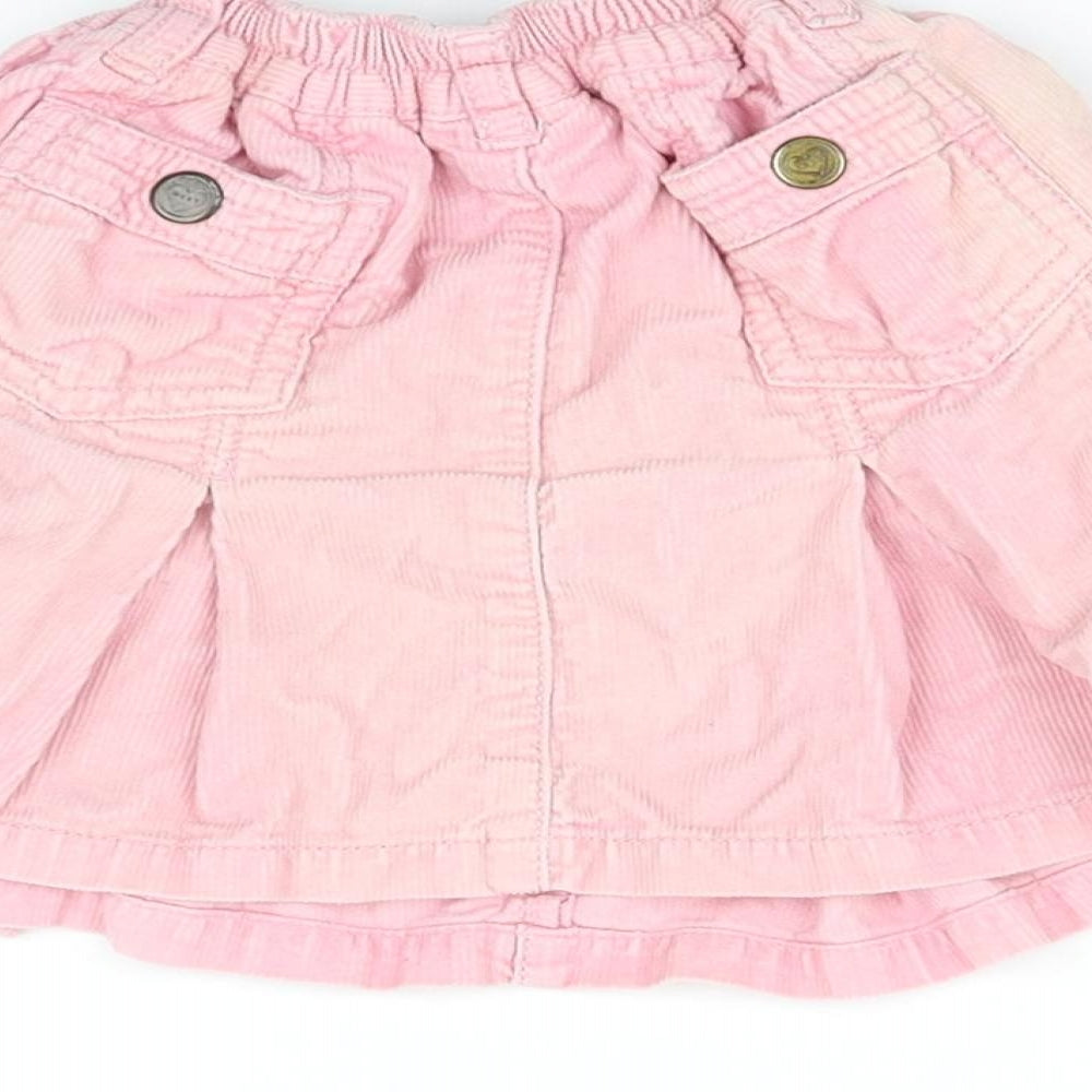 Brand and care label for Next girls’ pink mini skirt, size 2, years