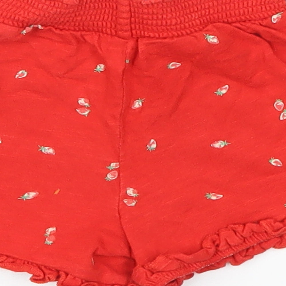 Brand and care label for Mothercare girls’ red cropped trousers, size 6-9, months - strawberries