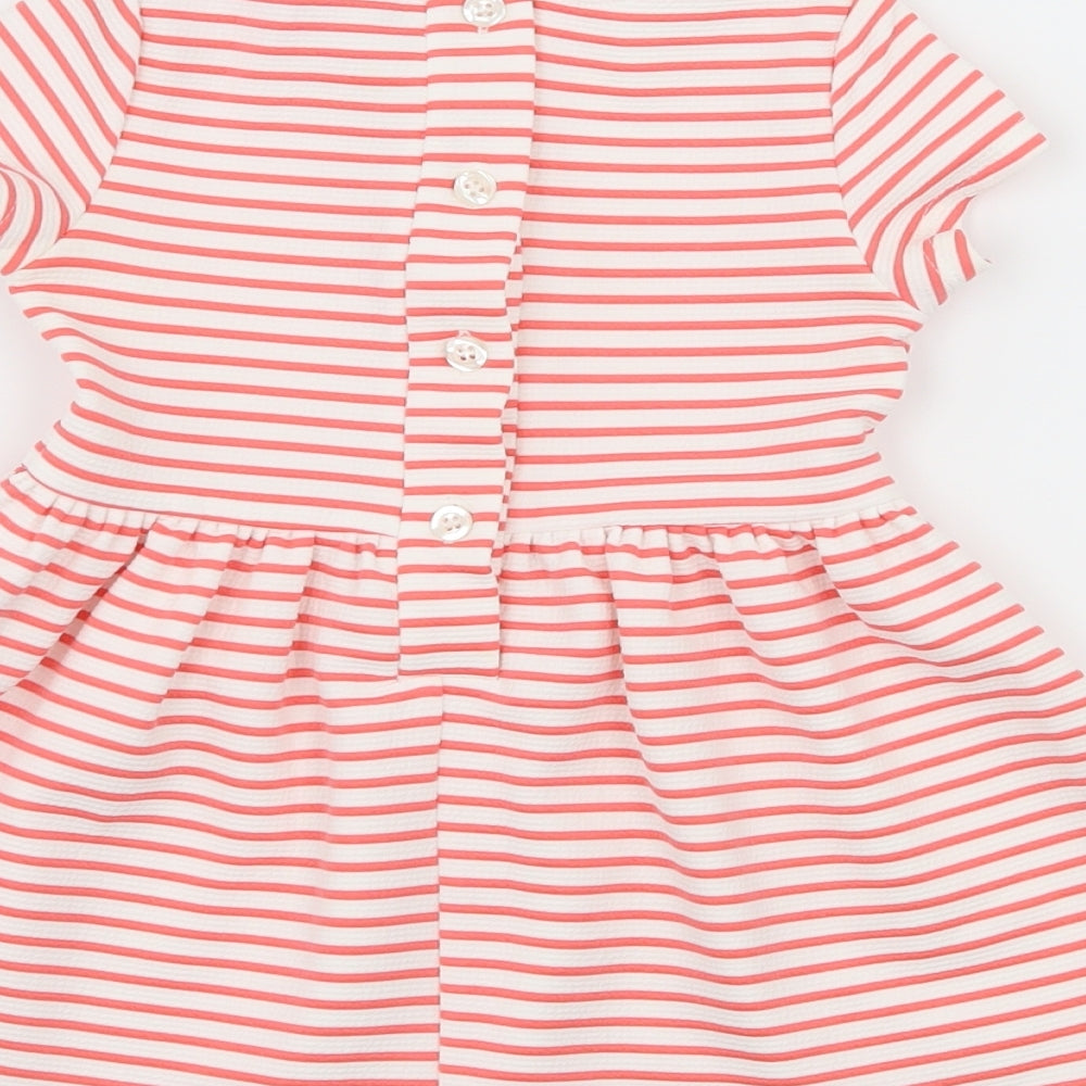 Brand and care label for Young Dimension girls’ pink striped jersey skater dress, size 12-18, months