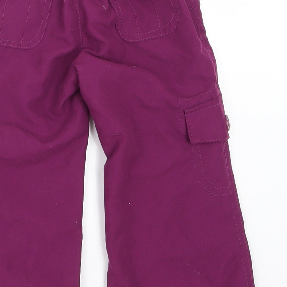 Brand and care label for Early Days girls’ purple cargo trousers, size 6-9, months