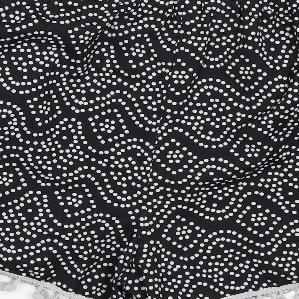 Brand and care label for Preworn women’s black polka dot sweat shorts, size M