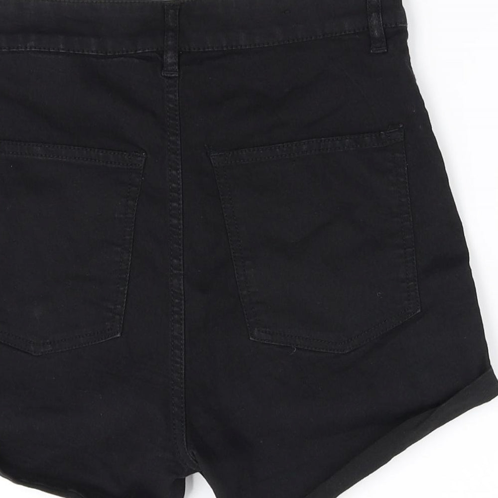 Brand and care label for Divided girls’ black cut-off shorts, size 10, years