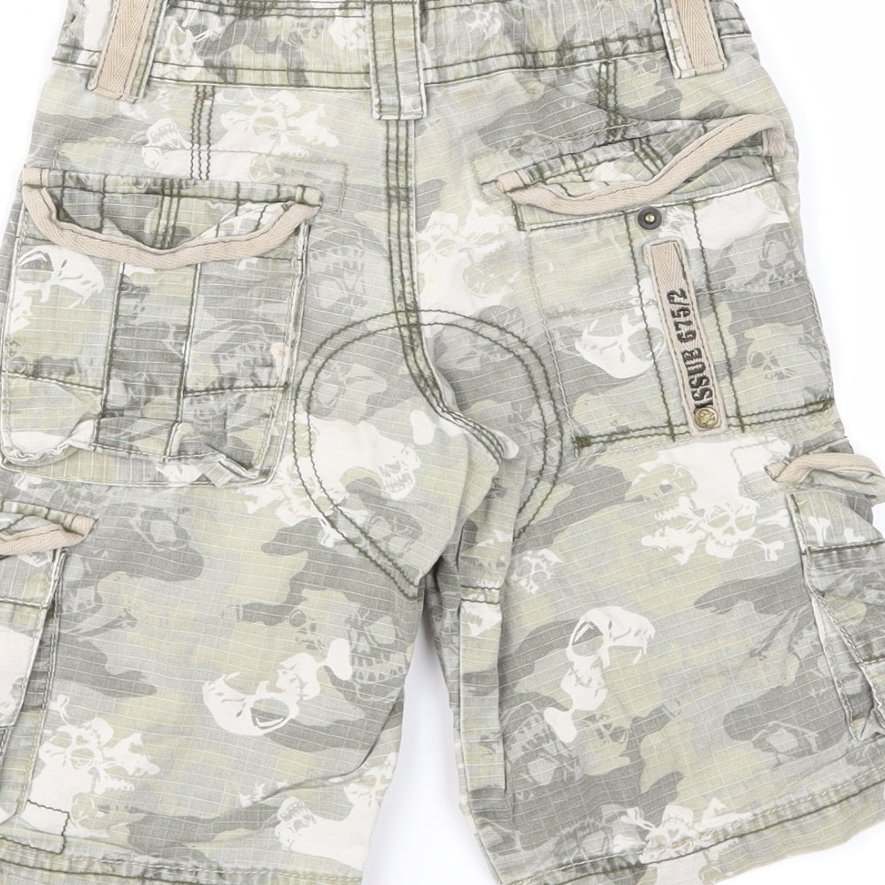 Brand and care label for Next boys’ green camouflage cargo shorts, size 4, years