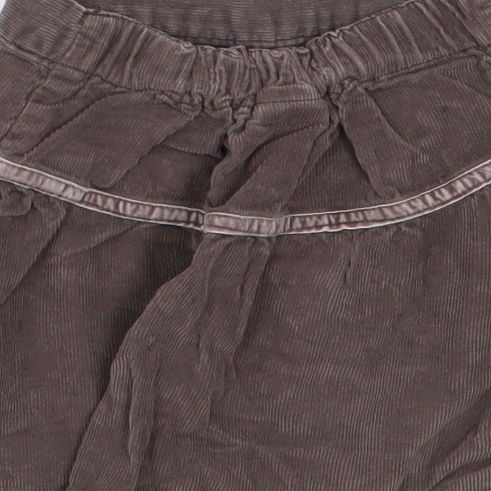 Brand and care label for Cherokee girls’ brown corduroy a-line skirt, size 3-4, years