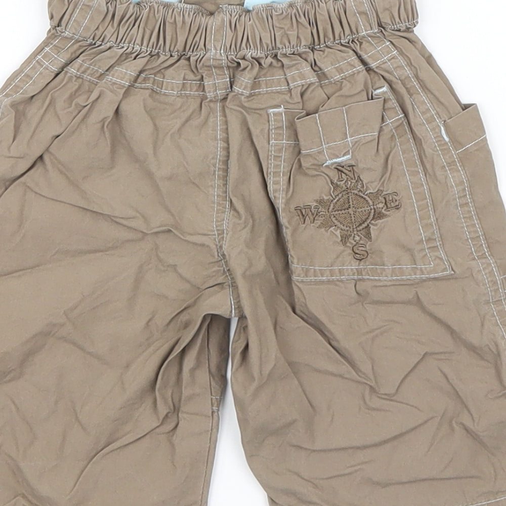 Brand and care label for Early Days boys’ brown cargo trousers, size 12-18, months