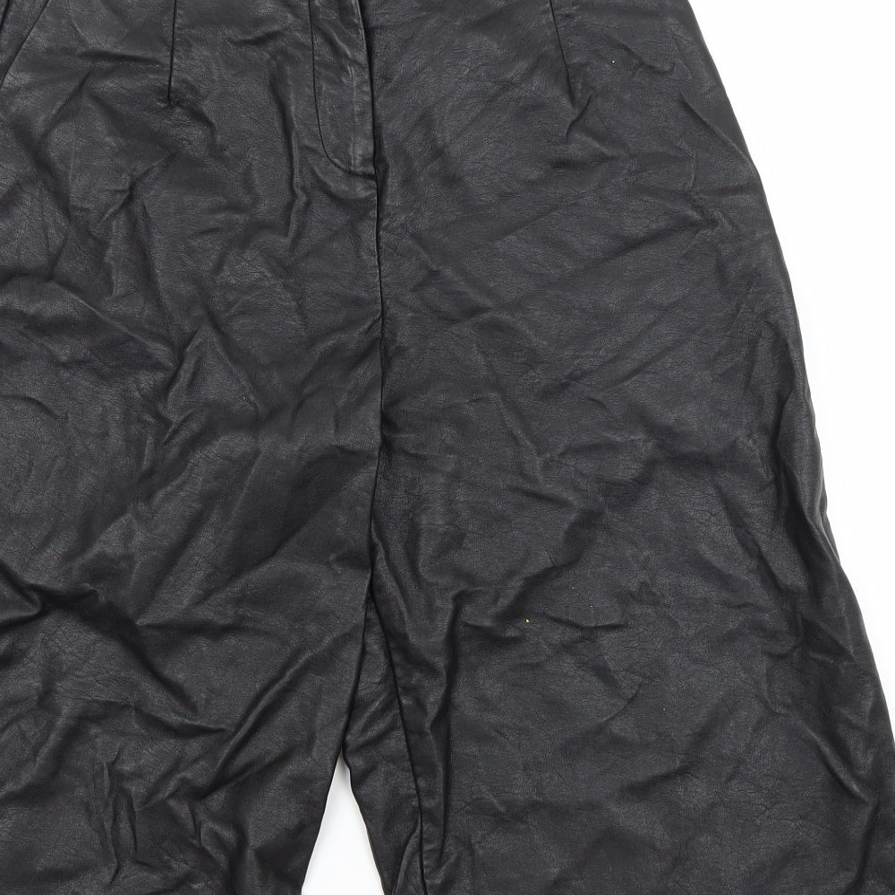 Brand and care label for Topshop women’s black utility shorts, size UK 8